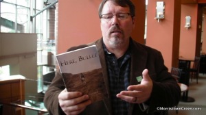 Turner holding his book of poems "Here, Bullet". Courtesy of morristowngreen.com