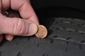 Placing a penny between the thread will tell you if the tire is old or worn out. Photo by Ammonslaw 